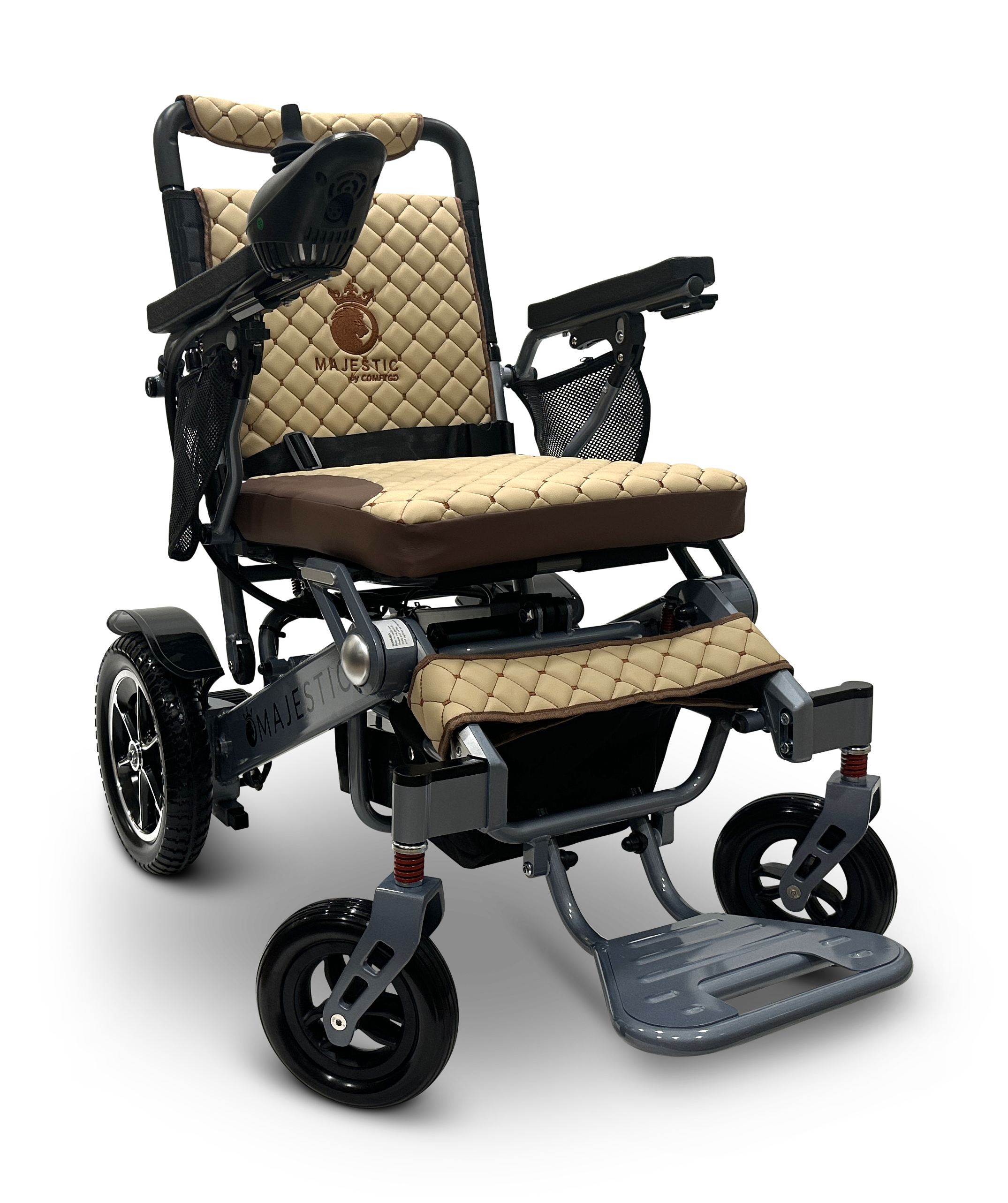 The MAJESTIC IQ-7000 is a beige and brown folding electric wheelchair with a quilted seat and backrest. It features black armrests, a 360-degree joystick for easy maneuvering, visible footrests, and larger rear wheels for added stability.